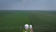 An aerial view shows a farmer loading soybeans from grain bins into a truck so they can be sold on August 01, 2025 in Dwight, Illinois. (Photo by SCOTT OLSON / GETTY IMAGES NORTH AMERICA / Getty Images via AFP)