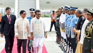 In this handout photograph taken on August 4, 2025 and released by the Indian Press Information Bureau (PIB), Philippines' President Ferdinand Marcos (2L) walks alongside India's Minister of State for External Affairs Pabitra Margherita (C) as he inspects the honour guards upon his arrival at the airport in New Delhi. Photo by Indian Press Information Bureau (PIB) / AFP