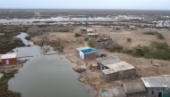 In this aerial photograph taken on June 25, 2025, abandoned houses are pictured in one of the villages of Kharo Chan town, in the Indus delta, south of Pakistan. (Photo by Israr Ahmed Khan / AFP) 