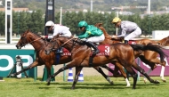 Laffan (in front) with Maxime Guyon aboard charges towards the finish.