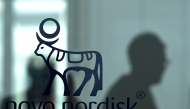 An employee walks past a door bearing the logo of Novo Nordisk at the factory in Hilleroed on September 26, 2023. Photo by Sergei GAPON / AFP