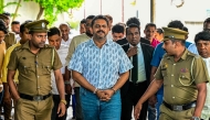 Police escort Sri Lanka's former Agriculture Minister Shasheendra Rajapaksa (centre) to a prison in Colombo on August 6, 2025. (Photo by Ishara S. Kodikara / AFP)

