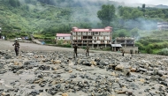 This handout photograph released on August 6, 2025 by the Indian Army shows security and relief personnel preparing to build a crossing across a stream of dense sludge and rocks during a search and rescue operation, a day after a cloudburst caused a massive mudslide and flash floods in India's Uttarakhand state. Photo by Indian Army / AFP