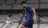 Al Duhail’s Homam Ahmed trains under the watchful eye of coach Djamel Belmadi during a session at Lusail Stadium.