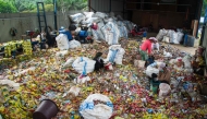 Women sort plastic waste at a workshop in Pekanbaru, Riau, on August 8, 2025. (Photo by Wahyudi / AFP)