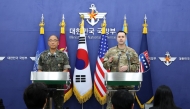 Col. Lee Sung-jun (L), public affairs director for South Korea's Joint Chiefs of Staff and Col. Ryan Donald, public affairs director of the United Nations Command (UNC), Combined Forces Command (CFC), and United States Forces Korea (USFK), attend the press briefing of the Ulchi Freedom Shield 2025 exercise at the Defense Ministry in Seoul on August 07, 2025. (Photo by Chung Sung-Jun / POOL / AFP)

