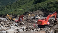 Rescuers clear rocks following flash floods in Yangwashan Village, Yuzhong County of northwest China's Gansu Province, Aug. 11, 2025. (Xinhua/Fan Peishen)