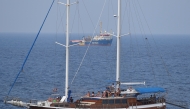 File photo: A tourist boat passes by search and rescue ship Sea-Watch 3 as it remains blocked near the island of Lampedusa, Italy, June 28, 2019. Reuters/Guglielmo Mangiapane