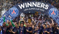 Paris Saint-Germain's Brazilian defender #05 Marquinhos lifts the trophy as Paris Saint-Germain celebrate winning the 2025 UEFA Super Cup final football match between Paris Saint-Germain (FRA) and Tottenham Hotspur FC (ENG) at the Friuli stadium, in Udine, on August 13, 2025. (Photo by FRANCK FIFE / AFP)
