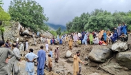 People gathered at the site of a flashflood in Salarzai Tehsil of Pakistan's Bajaur district on August 15, 2025. Photo by AFP
