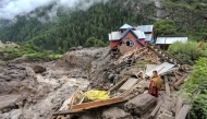 A woman looks on as she stands near a damaged house at the site of a flashflood at a village in Kishtwar district on August 15, 2025. Photo by Mir Imran / AFP)
