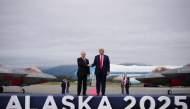 US President Donald Trump greets Russian President Vladimir Putin as he arrives at Joint Base Elmendorf-Richardson on August 15, 2025 in Anchorage, Alaska. (Photo by Andrew Harnik / Getty Images via AFP)
