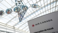 An Air Canada labour dispute sign is seen at the Pierre-Elliot Trudeau Airport in Montreal, Quebec, Canada, on August 15, 2025. (Photo by Andrej Ivanov / AFP)