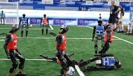 Robots compete in a 5x5 football match during the World Humanoid robots games in Beijing on August 16, 2025. (Photo by Adek Berry / AFP)