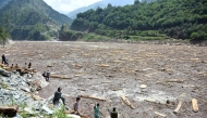 Locals collect woods from Noseri Dam near Muzaffarabad, the capital of Pakistan-administered Kashmir, on August 16, 2025. (Photo by Sajjad Qayyum / AFP)