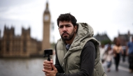 Diego Galdino, who hunts and films pickpockets in London and posts the footage on social media, poses on Westminster Bridge in London on August 7, 2025. (Photo by Henry Nicholls / AFP)