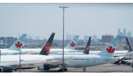 Air Canada airplanes stand on the tarmac at Pearson International Airport in Toronto on August 16, 2025. (Photo by Peter Power / AFP)