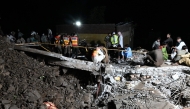 Rescue workers and residents search for victims in the debris of collapsed houses after a cloudburst in Dolari village, Swabi district, in northern Pakistan's mountainous Khyber Pakhtunkhwa province, on August 18, 2025. (Photo by Aamir Qureshi / AFP)
 