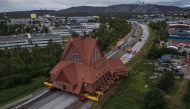 The wooden Kiruna Church is transferred to its new location, in Kiruna, Sweden on August 20, 2025. (Photo by Jonathan Nackstrand / AFP)