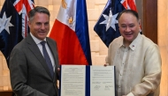 Philippine Defence Minister Gilberto Teodoro (R) and Australian Deputy Prime Minister and Minister for Defence Richard Marles (L) pose for a photo after signing the statement of intent for the enhanced defence cooperation in Makati, Metro Manila on August 22, 2025. (Photo by Jam STA ROSA / AFP)