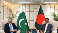This handout photograph taken on August 24, 2025 and released by Bangladesh's Ministry of Foreign Affairs shows Foreign Affairs Advisor of Bangladesh's interim government Mohammad Touhid Hossain (right) and Pakistan's Foreign Minister Ishaq Dar during a bilateral meeting in Dhaka. (Photo by Bangladesh's Ministry of Foreign Affairs / AFP)
