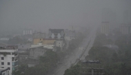 Rain falls above the buildings and a street in Vinh city, Nghe An province on August 25, 2025, before Typhoon Kajiki makes landfall in Vietnam. (Photo by Nhac Nguyen / AFP)