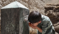 (Files) An Afghan Hazara boy drinks water from a tap in Qavariyak village in Shibar district of Bamiyan province on June 18, 2025. (Photo by Mohammad Faisal Naweed / AFP)