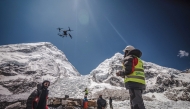 In this handout photograph taken on May 11, 2025 and released by Airlift Technology, a man operates a heavy-lift drone to clear trash dumped at the Everest Base Camp. Photo by Airlift Technology / AFP