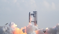 SpaceX's Starship rocket lifts off from Starbase, Texas, as seen from South Padre Island on August 26, 2025, for its tenth test flight. (Photo by Ronaldo Schemidt / AFP)