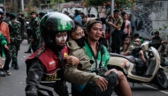 Protesters carry away a man who appears to be injured during a protest against the Mobile Brigade Corps, or 'Brimob', following the death of a motorcycle taxi driver the night before, in front of the Brimob headquarters in Jakarta on August 29, 2025. Photo by Aditya Aji / AFP.