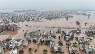 This aerial view shows partially submerged residential buildings following the overflowing of the Ravi River in Lahore on August 30, 2025. (Photo by Aamir Qureshi / AFP)