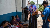Relatives of minors deported from the United States gather outside of the Returnee Reception Center while waiting for their arrival at the Guatemalan Air Force Base in Guatemala City on August 31, 2025. (Photo by Johan Ordonez / AFP)