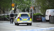 Police officers cordon off the scene after several people were killed in a shooting at Vaksala Square in central Uppsala, Sweden on April 29, 2025. (Photo by Fredrik SANDBERG / various sources / AFP)

