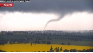 This screengrab from handout surveillance camera footage taken and released by New South Wales Rural Fire Service (NSW RFS) on September 10, 2025 shows a tornado over the countryside near Young in New South Wales. (Photo by Handout / NSW Rural Fire Service (NSW RFS) / AFP) 