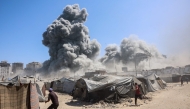 Smoke billows in Gaza City after Israeli strikes on a tower on September 10, 2025. (Photo by Omar Al-Qattaa / AFP)
