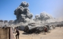 Smoke billows in Gaza City after Israeli strikes on a tower on September 10, 2025. (Photo by Omar Al-Qattaa / AFP)
