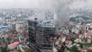 Smoke billows from the burning Hilton Hotels, a day after it was set ablaze by protesters in Kathmandu on September 10, 2025. (Photo by Prabin Ranabhat / AFP)