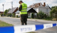 Police and army inspect damage to a house destroyed by debris from a shot down Russian drone in the village of Wyryki-Wola, eastern Poland, on September 10, 2025. (Photo by Wojtek Radwanski / AFP)