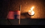A US flag and a candle sit on a step during a candlelight vigil and prayer event for Turning Point USA Founder Charlie Kirk on September 10, 2025 in Seattle, Washington. David Ryder/Getty Images/AFP 