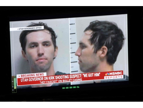 A TV monitor displays a picture of Tyler Robinson, the suspected of killing Charlie Kirk on September 11, in Orem, Utah, on September 12, 2025. (Photo by Patrick T. Fallon / AFP)
