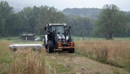 Cattle farmer Josef Hadler mows a meadow with his tractor on the border between Austria and Slovenia on September 10, 2025. (Photo by Joe Klamar / AFP)