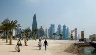 Municipal workers clean Qatar's capital Doha's seaside Corniche on September 10, 2025. (Photo by Karim Jaafar / AFP)