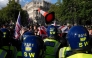 A traffic cone is thrown towards police officers as supporters of British far-right activist Tommy Robinson gather during a 'Free speech' march, in central London on September 13, 2025. (Photo by Carlos Jasso / AFP)
 