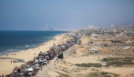 Displaced Palestinians move with their belongings southwards on a road in the Nuseirat refugee camp area in the central Gaza Strip following renewed Israeli evacuation orders for Gaza City on September 14, 2025. (Photo by Eyad Baba / AFP)
