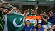 Pakistan and India fans cheer before the start of the Asia Cup 2025 Twenty20 international cricket match between India and Pakistan at the Dubai International Stadium in Dubai on September 14, 2025. (Photo by Fadel Senna / AFP)