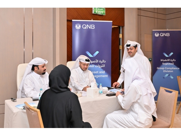 Officials and Qatari graduates during the event. 