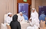 Officials and Qatari graduates during the event. 