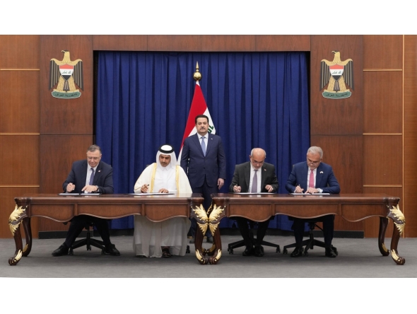 Prime Minister of Iraq H E Mohammed Shia Al-Sudani looks on as Minister of State for Energy Affairs, President and CEO of QatarEnergy, H E Saad Sherida Al-Kaabi; Chairman and CEO of TotalEnergies, Patrick Pouyanné; and other officials sign documents at a ceremony held in Baghdad yesterday.