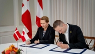 Denmark's Prime Minister Mette Frederiksen (L) and Greenland's government leader Jens Frederik Nielsen sign a framework agreement for a self-sustaining Greenland at the Prime Minister's Office in Copenhagen, Denmark, on September 16, 2025. (Photo by Mads Claus Rasmussen / Ritzau Scanpix / AFP) 