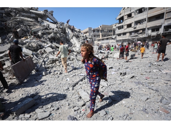 Displaced Palestinians salvage items from the rubble of the al-Ghafari tower after it was destroyed in Israeli strikes in Gaza City on September 15, 2025. Photo by Omar AL-QATTAA / AFP
